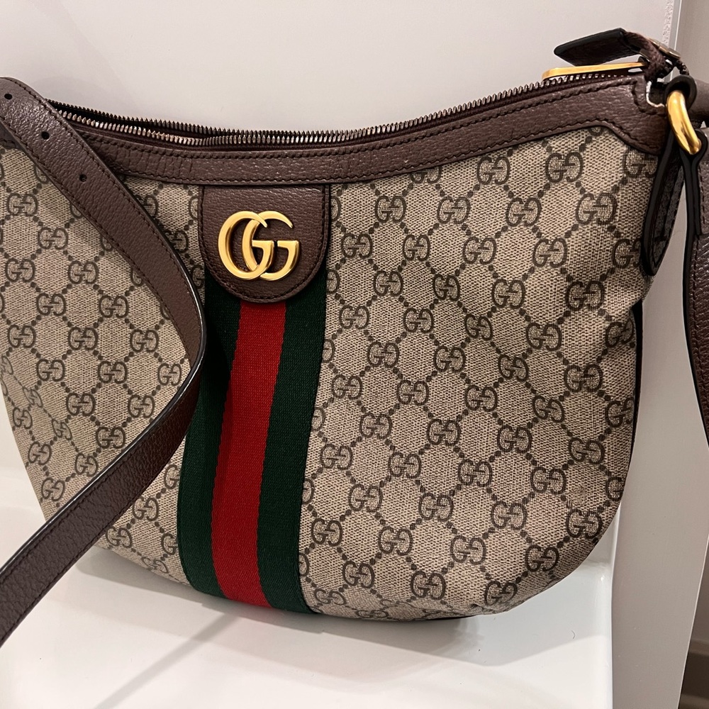 GUCCI
GG Supreme Monogram Web Small Ophidia Half Moon Hobo Brown